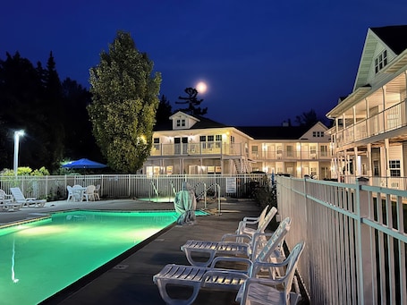Seasonal outdoor pool, open 9:00 AM to 9:30 PM, pool umbrellas. Bay Breeze Resort