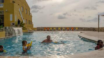 Relax by the pool surrounded by a serene waterfall and lounge in style with comfortable seating.