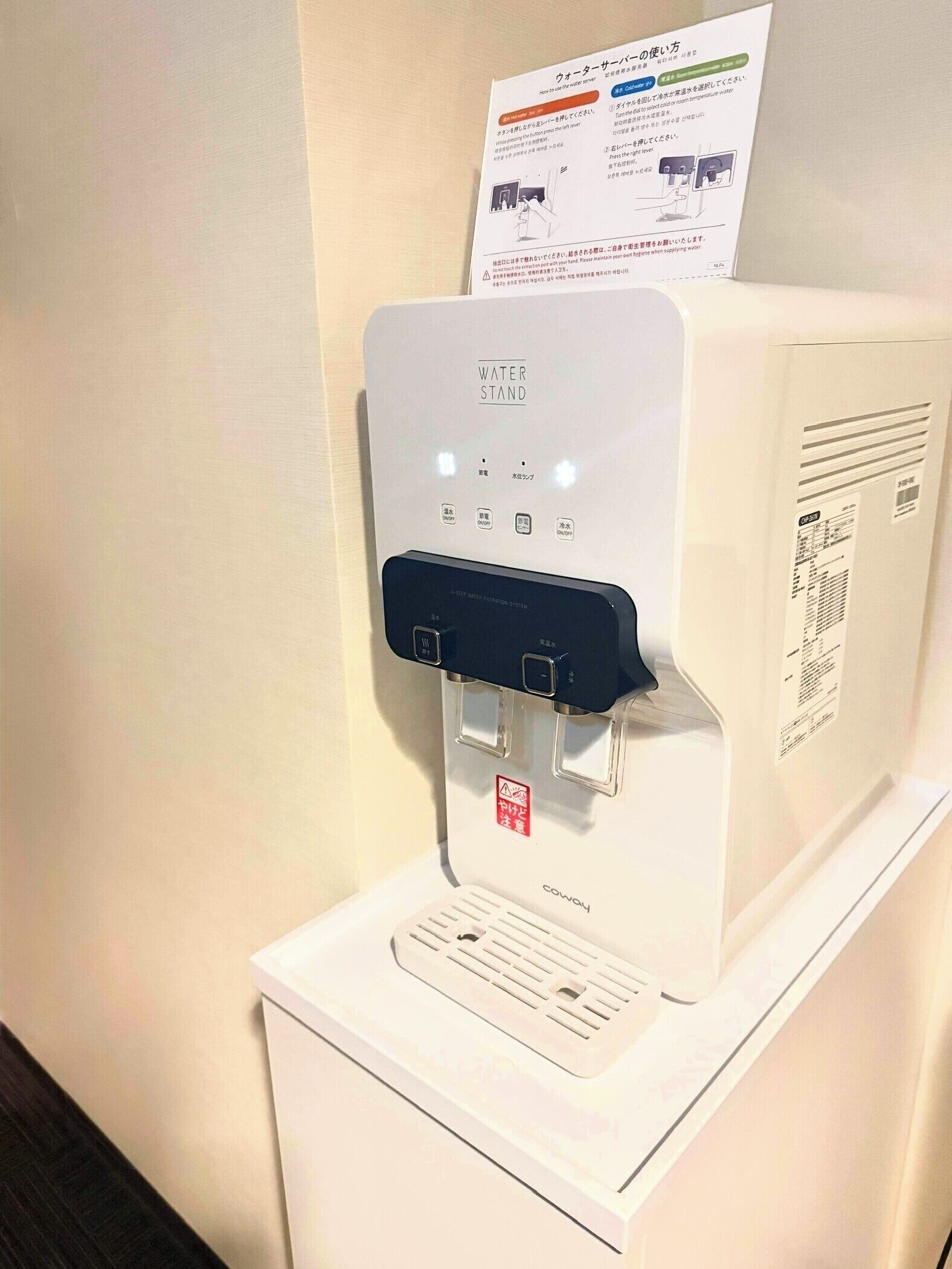 A water dispenser with a control panel and a water bottle holder.