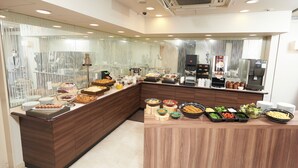 A buffet setup with various food items and a coffee station. - Keio Presso Inn Ikebukuro (Tokyo)
