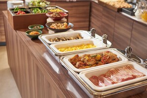 A buffet with various dishes including salads, meats, and cheeses. - Keio Presso Inn Ikebukuro (Tokyo)