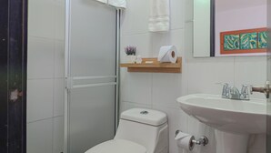 A modern bathroom with a toilet, sink, and shower. - Hotel Volare (Armenia)