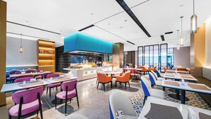A modern restaurant with a central bar area, multiple dining tables and chairs, and large windows offering views. - Hangzhou Wassim Resorts Hotel  (Hangzhou)