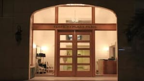 The entrance to Edificio Plaza Paris with a large glass door and a sign above it. - Amistar Plaza París (Santiago)