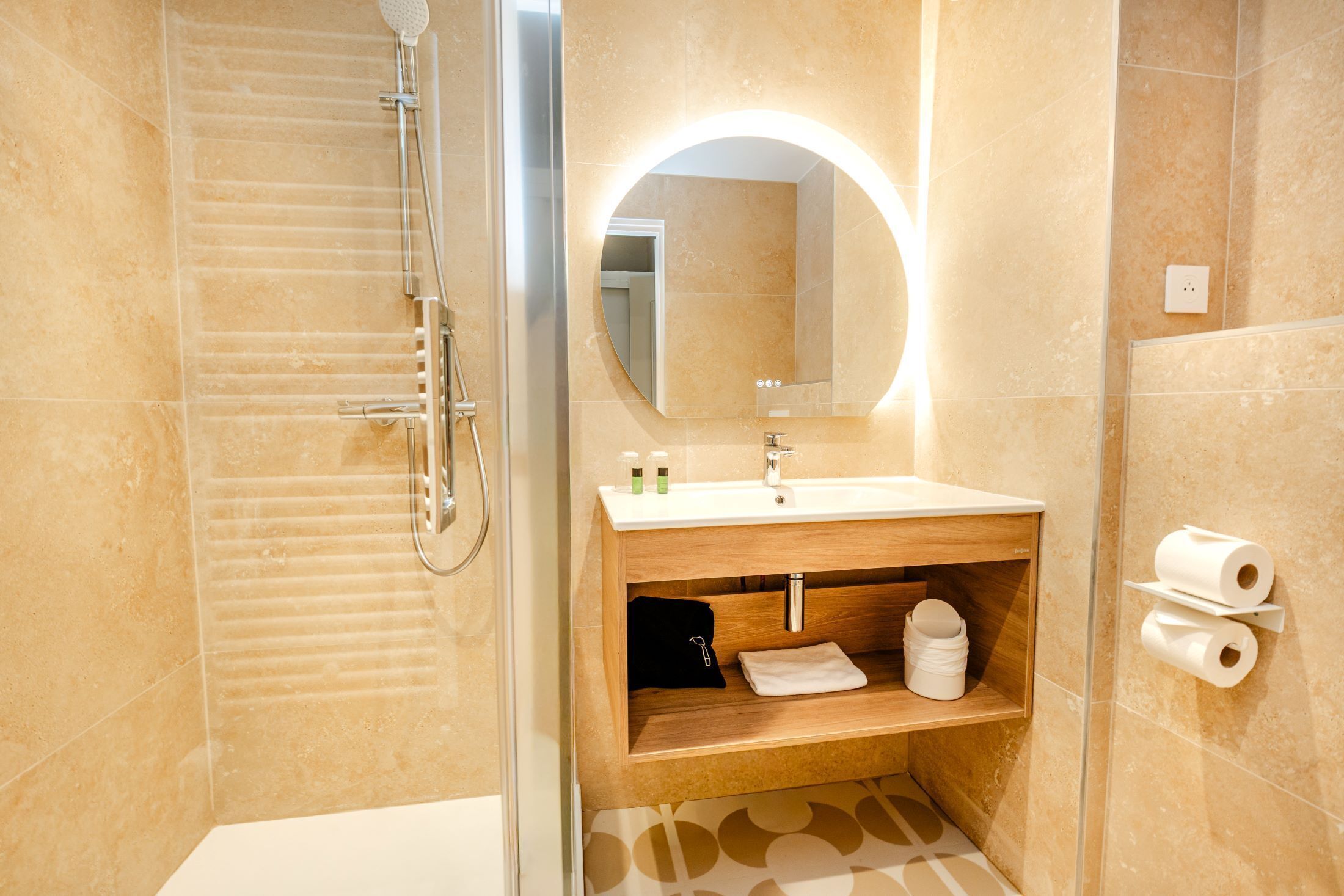 A modern bathroom with a shower, a sink with a mirror, and a towel rack.