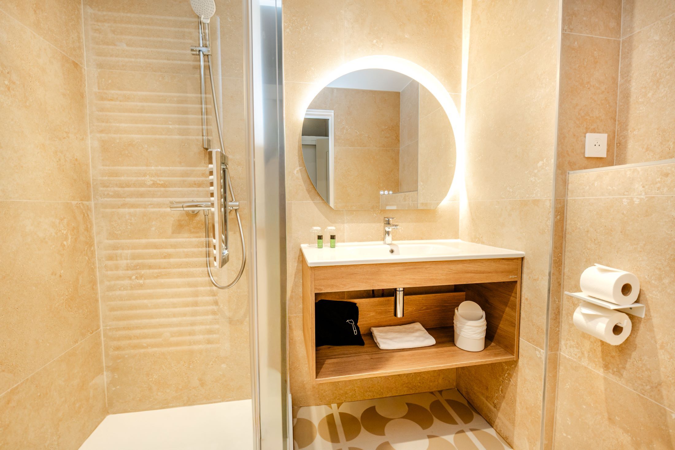 A modern bathroom with a shower, a sink with a mirror, and a towel rack.