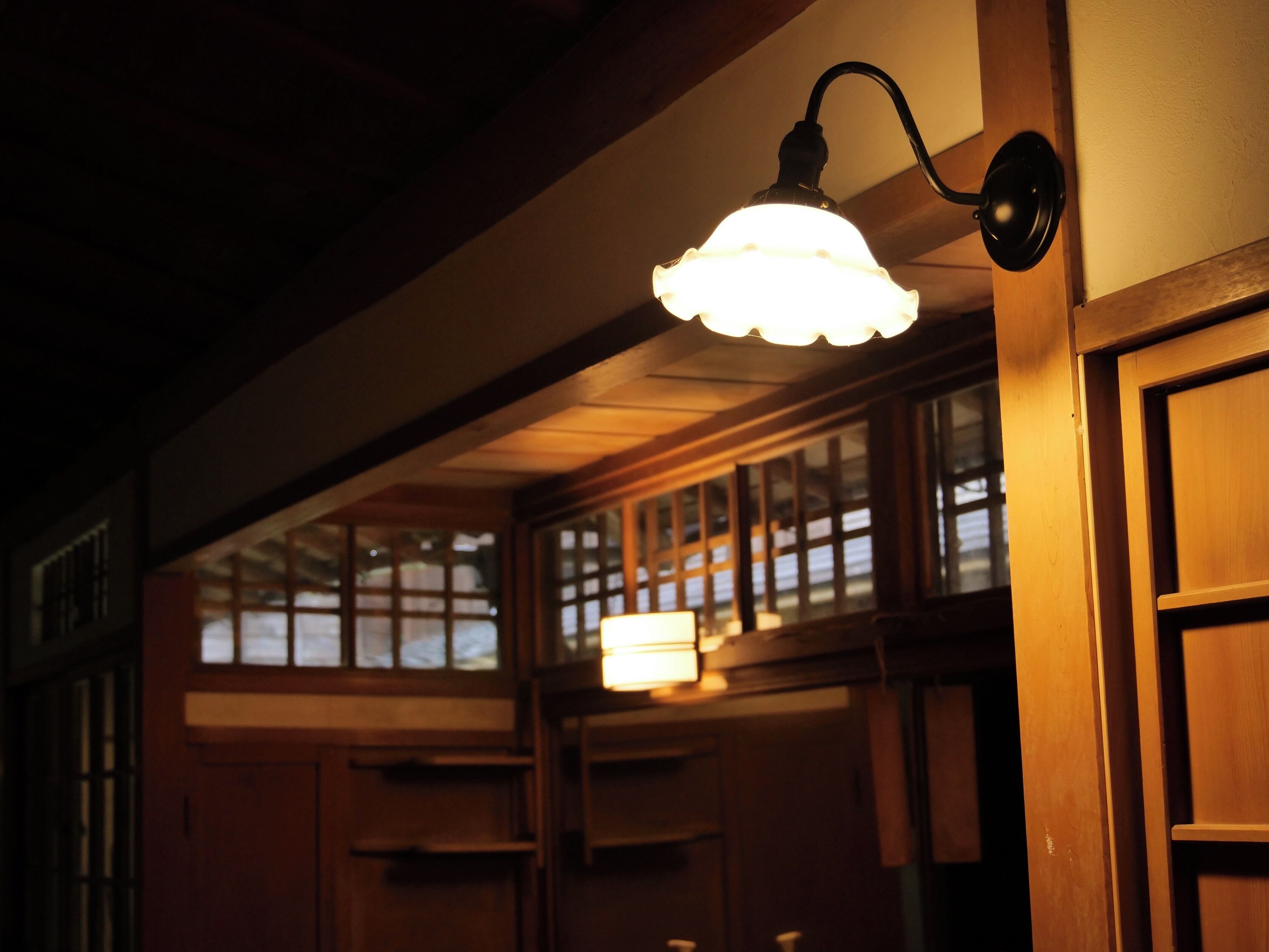 A traditional interior with wooden paneling and a hanging light fixture.