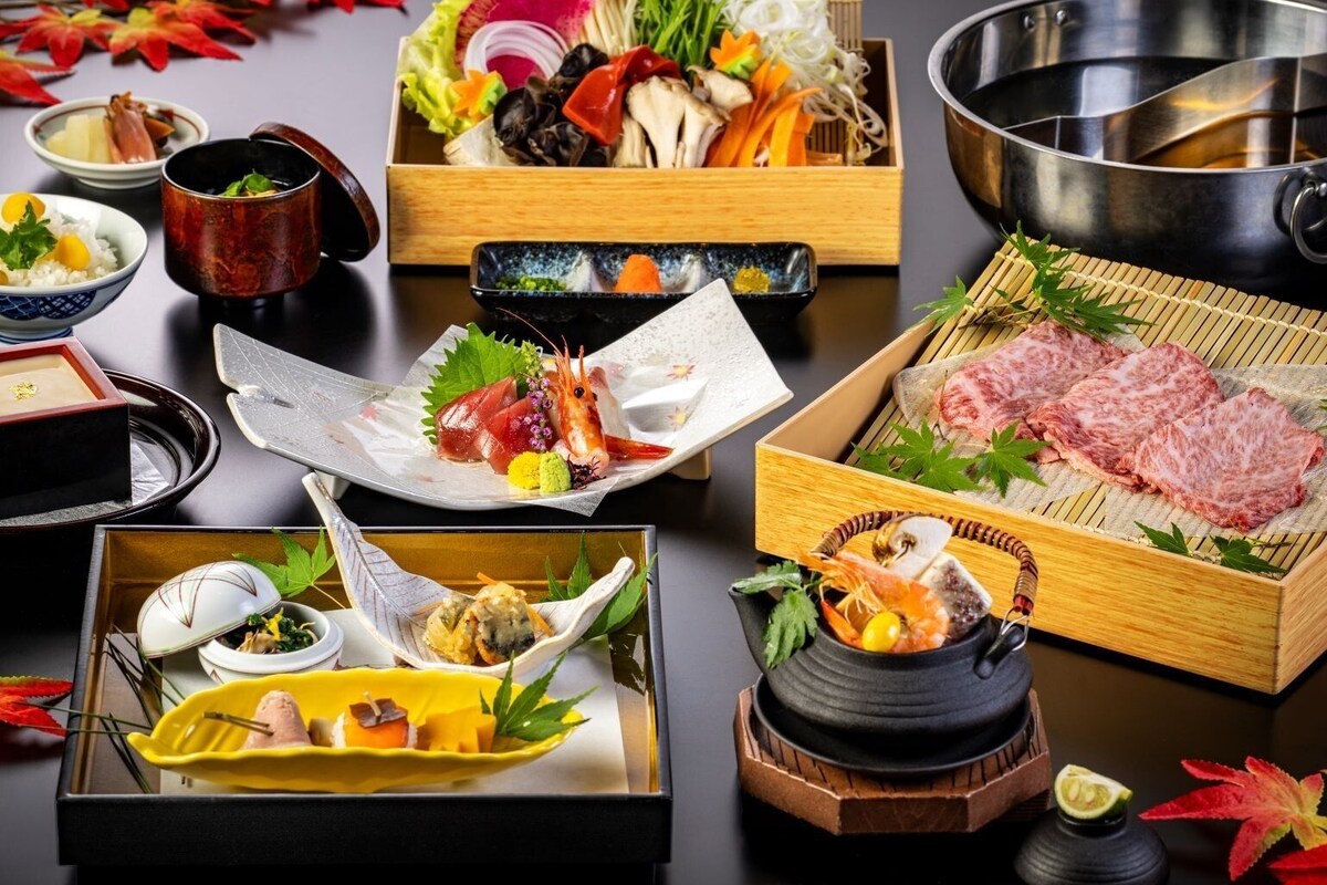 A variety of Japanese dishes arranged on a table, including sushi, sashimi, and other delicacies.
