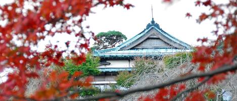 A traditional Japanese building with a tiled roof and a prominent central spire.