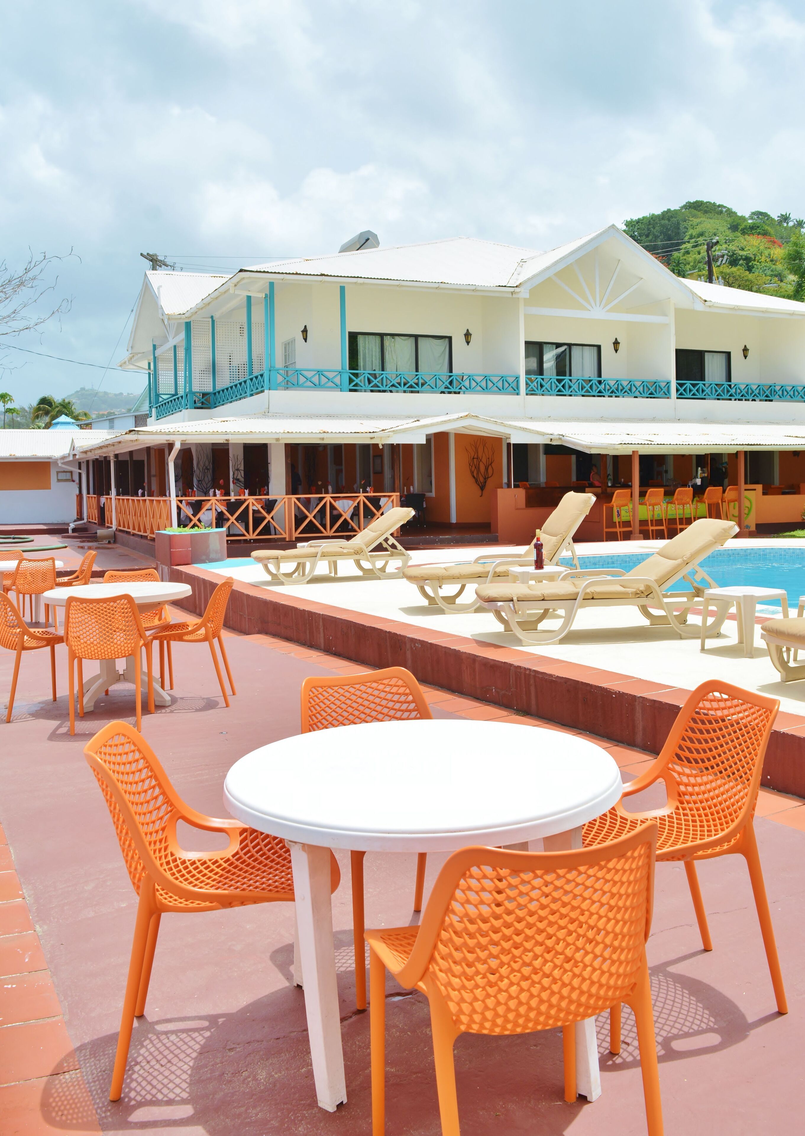 A resort with outdoor seating and a pool.