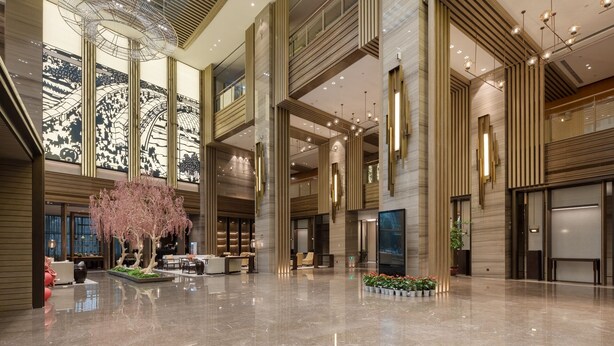 A spacious lobby with a large chandelier, seating areas, and a decorative tree. -  Hangzhou Xingdu Hotel (Hangzhou)