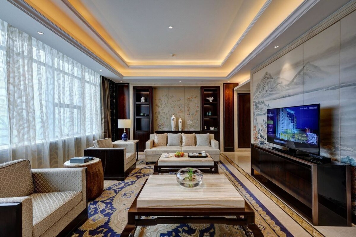 A modern living room with a sofa, coffee table, and television.