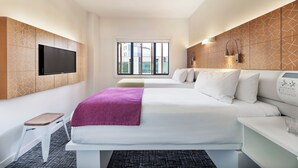 A hotel room with a large bed, a TV mounted on the wall, a window with a view, and a bedside table with a lamp. - BreakFree on Cashel Christchurch (Christchurch)