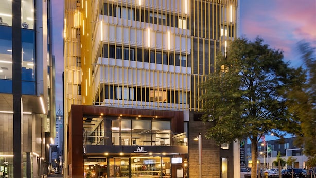 A modern building with multiple floors, large windows, and a visible restaurant named 'Accor Live Limitless'. - BreakFree on Cashel Christchurch (Christchurch)