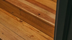 A wooden staircase with a dark door frame. - Oporto Maison Sol   (Porto)