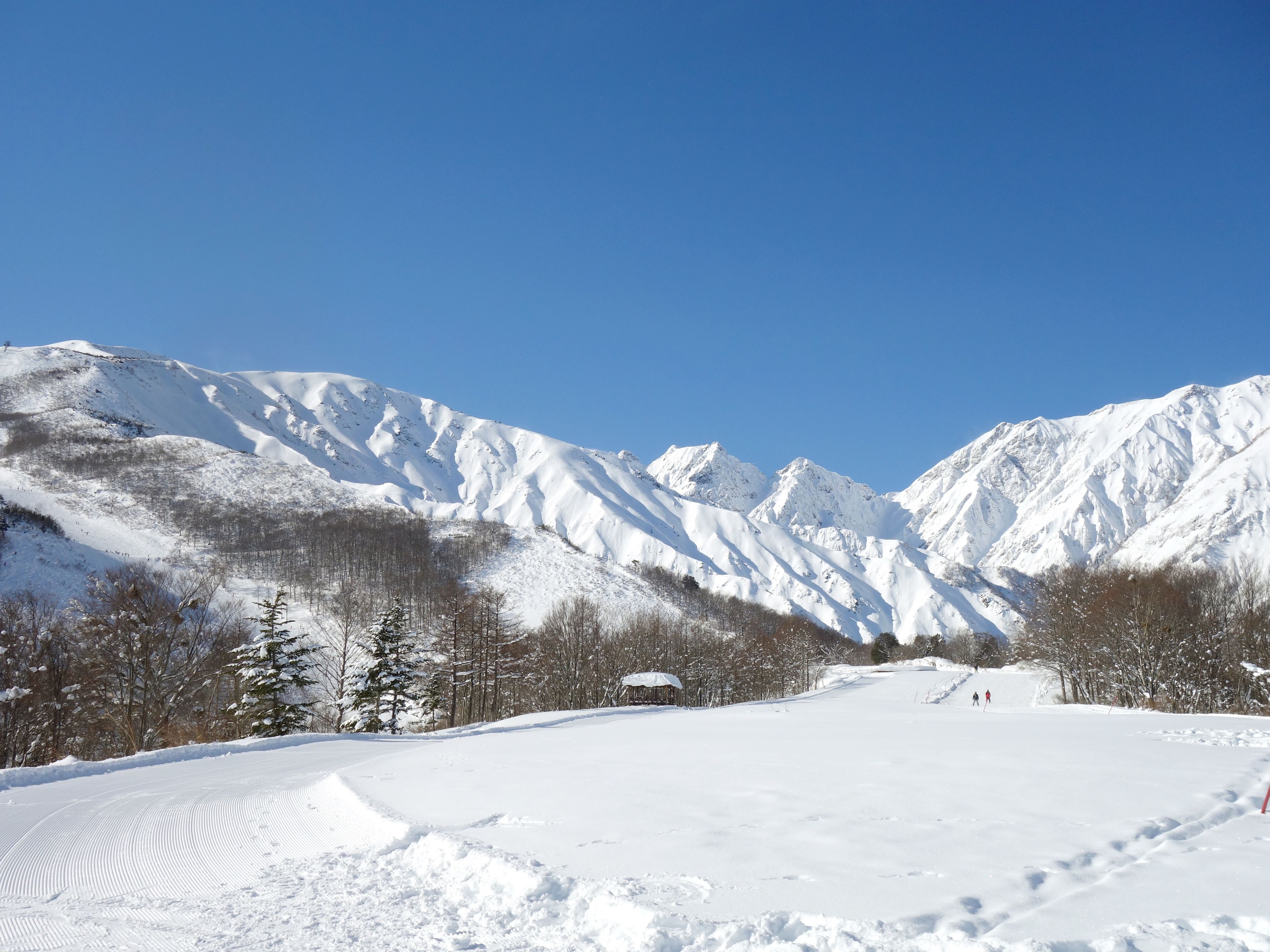 A snow-covered mountain landscape with a clear sky.