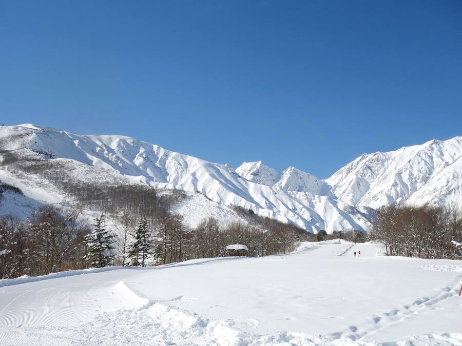 A snow-covered mountain landscape with a clear sky.