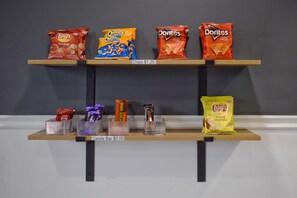 A shelf with snacks and candy bars.