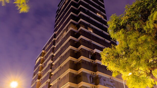 A high-rise building with multiple balconies and a curved glass facade. - J&A Classic Hotel (Lima)
