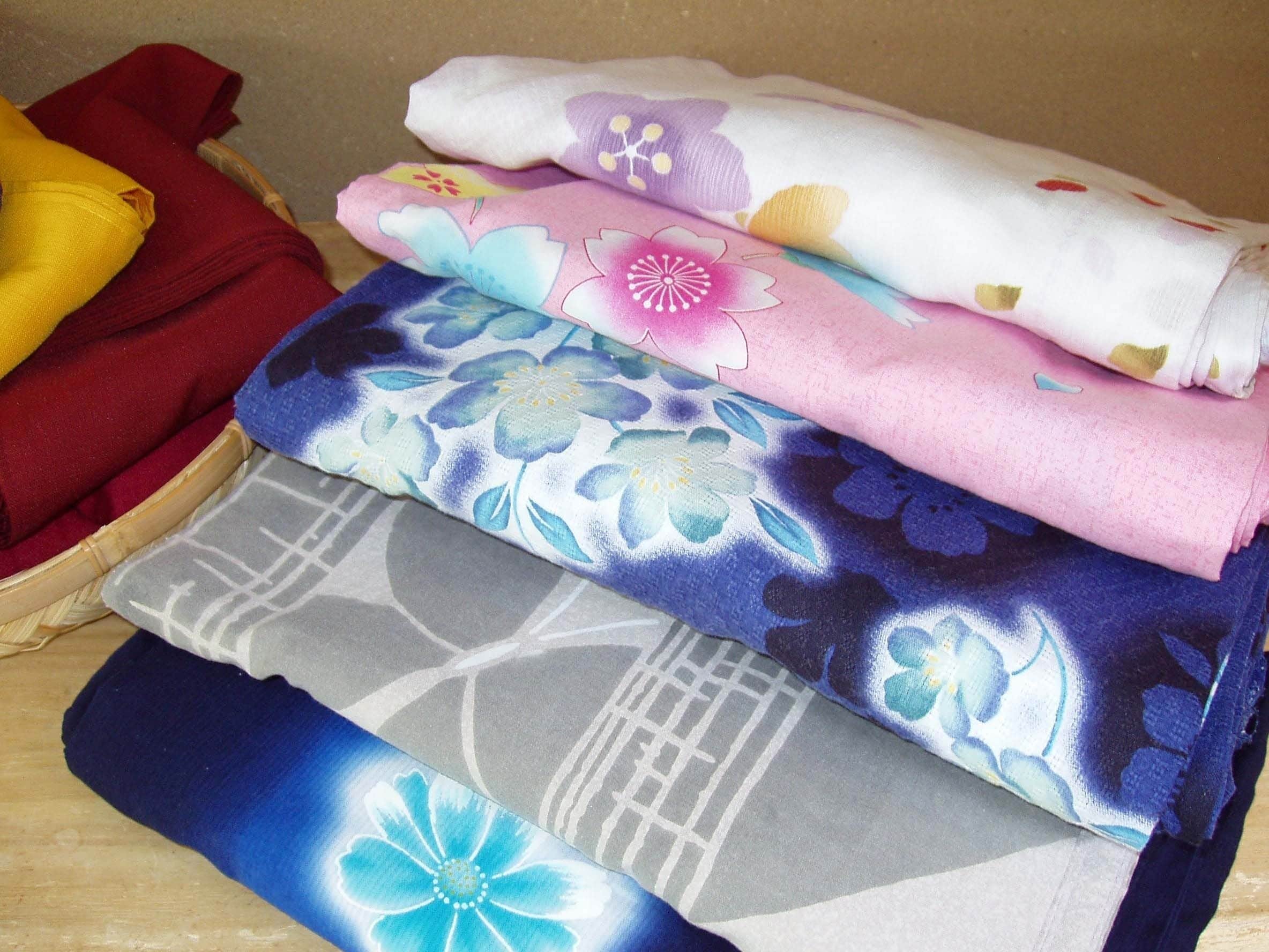A stack of folded towels with floral patterns.