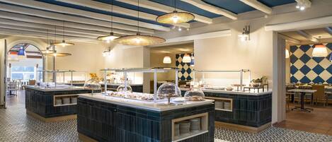 A modern breakfast bar area with a checkered floor pattern, blue and white ceiling beams, and pendant lighting.