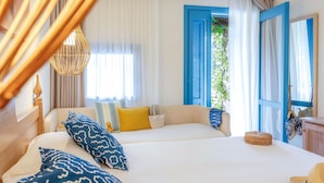 A hotel room with two beds, a large window with blue shutters, a wicker basket, and a straw hat on the bed. - TUI BLUE Budoni (Budoni)
