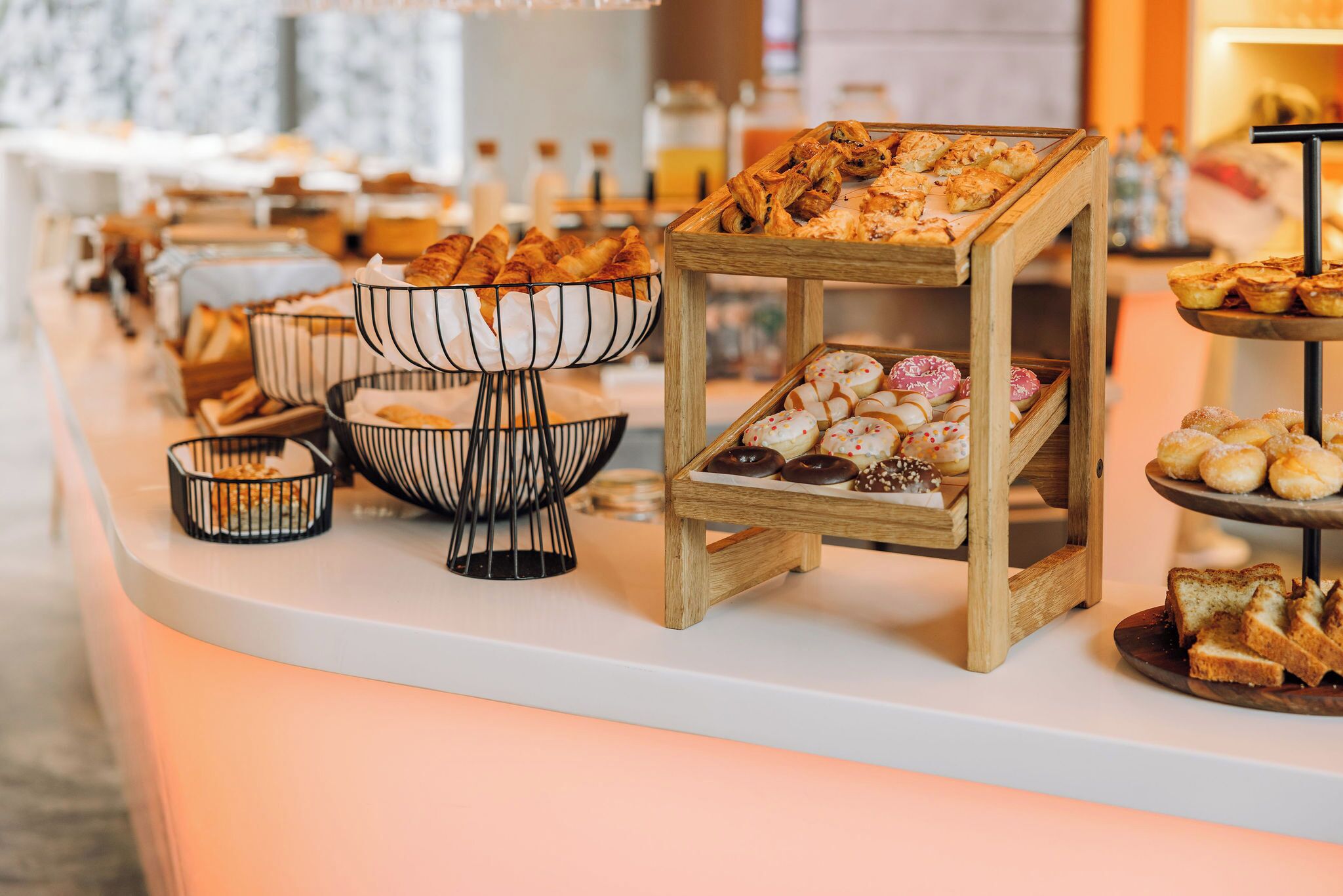 A buffet with various baked goods and pastries.