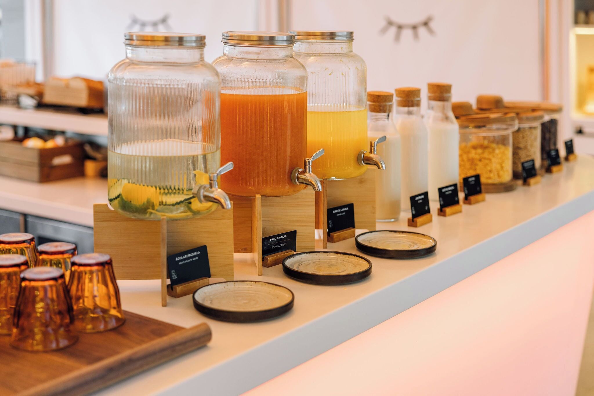 A beverage station with multiple drink dispensers and labels.