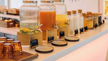 A beverage station with multiple drink dispensers and labels.