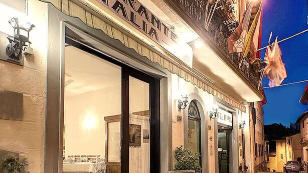 A restaurant named "Ristorante Italia" with outdoor seating and a signboard. - Hotel Italia Ristorante Pizzeria (Reggello)