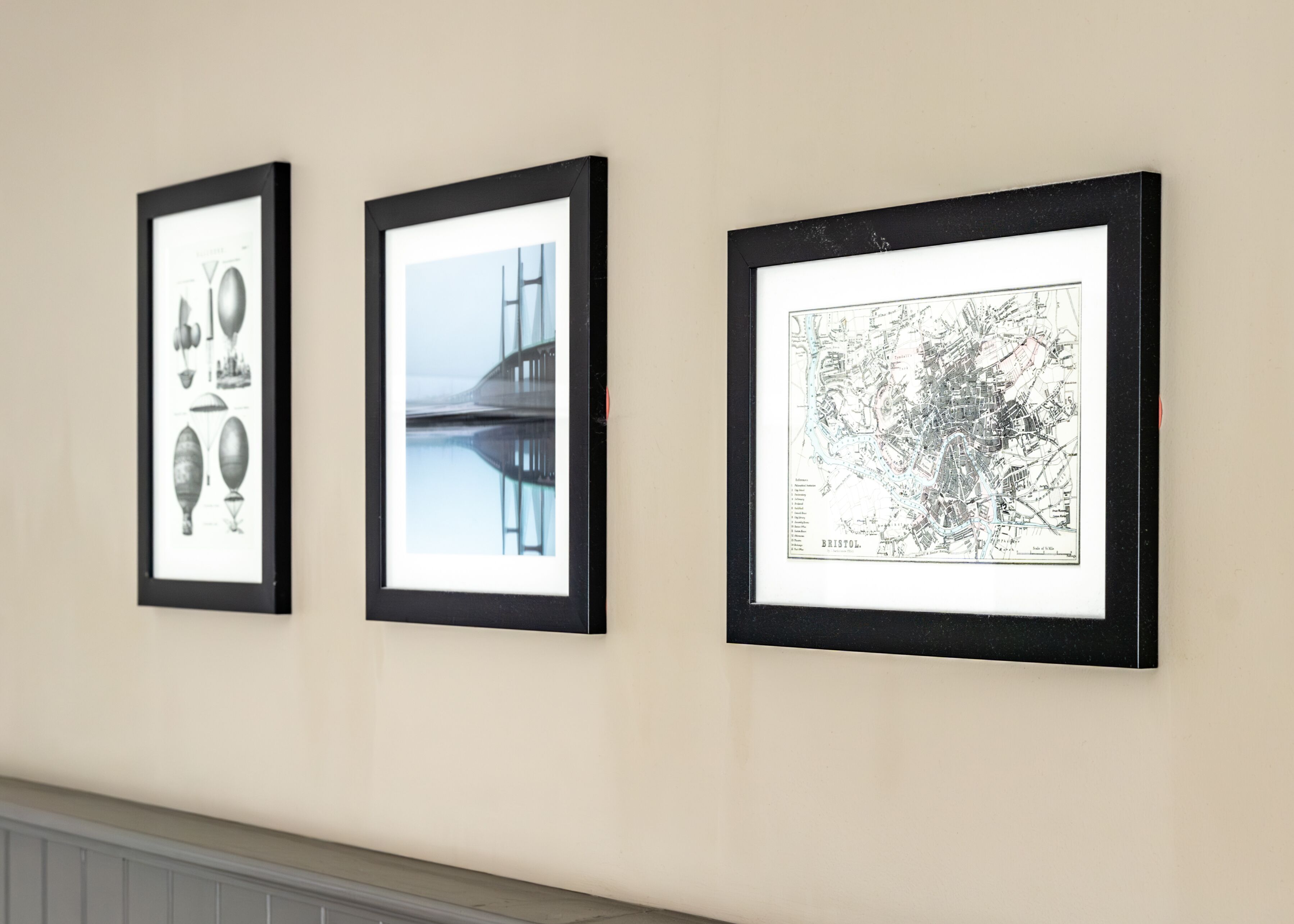 Three framed pictures on a wall.