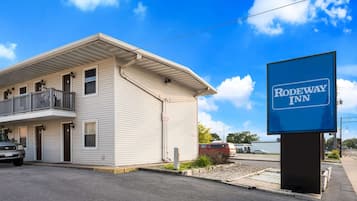 Situated on a quiet street, this two-story building features a flat roof and a second-floor balcony.