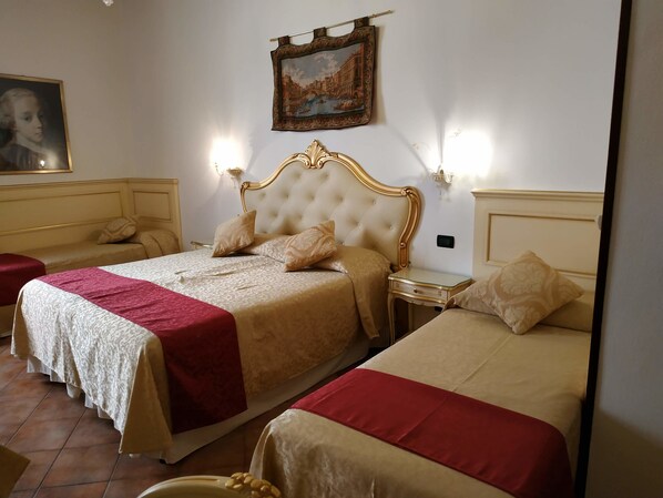 Habitación de hotel con dos camas, un cuadro grande en la pared y un diseño clásico.