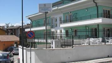 A hotel with a sign indicating it is a hotel and restaurant named San Bernardo.