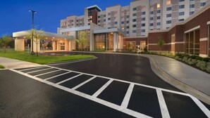 A modern hotel with a prominent "Embassy Suites" sign, a spacious entrance, and a well-maintained driveway. - Embassy Suites by Hilton Chicago Naperville (Naperville)