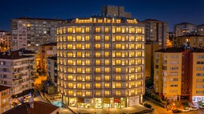 A multi-story hotel with a circular facade, numerous windows, and a central entrance. - The Leos Residence (Istanbul)