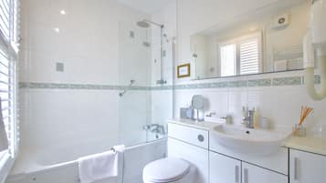 A modern bathroom with a bathtub, toilet, and sink.
