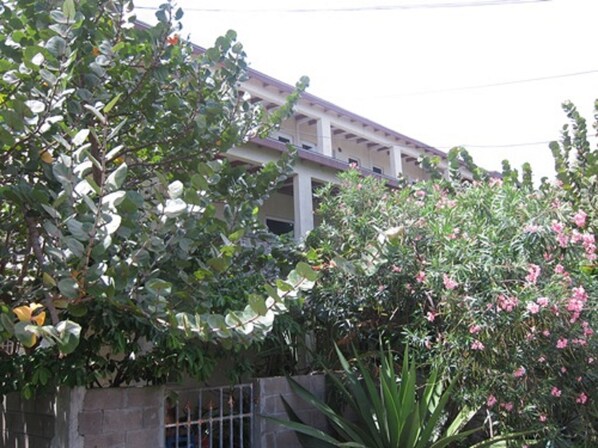 A building with a tiled roof and a stone wall.