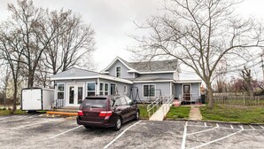 A two-story house with a garage, a driveway, and a fenced yard.