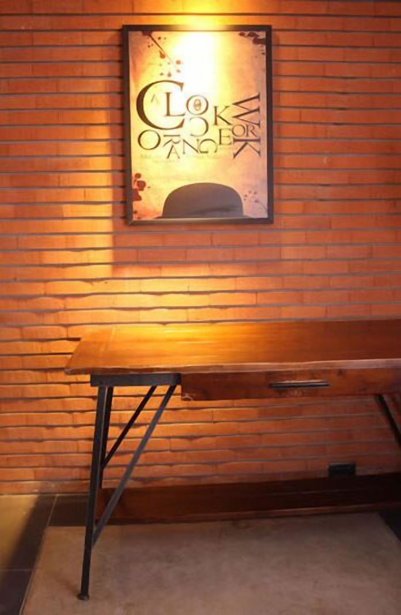 A wooden wall with a framed sign that reads "A COKE OF O'NEILL."