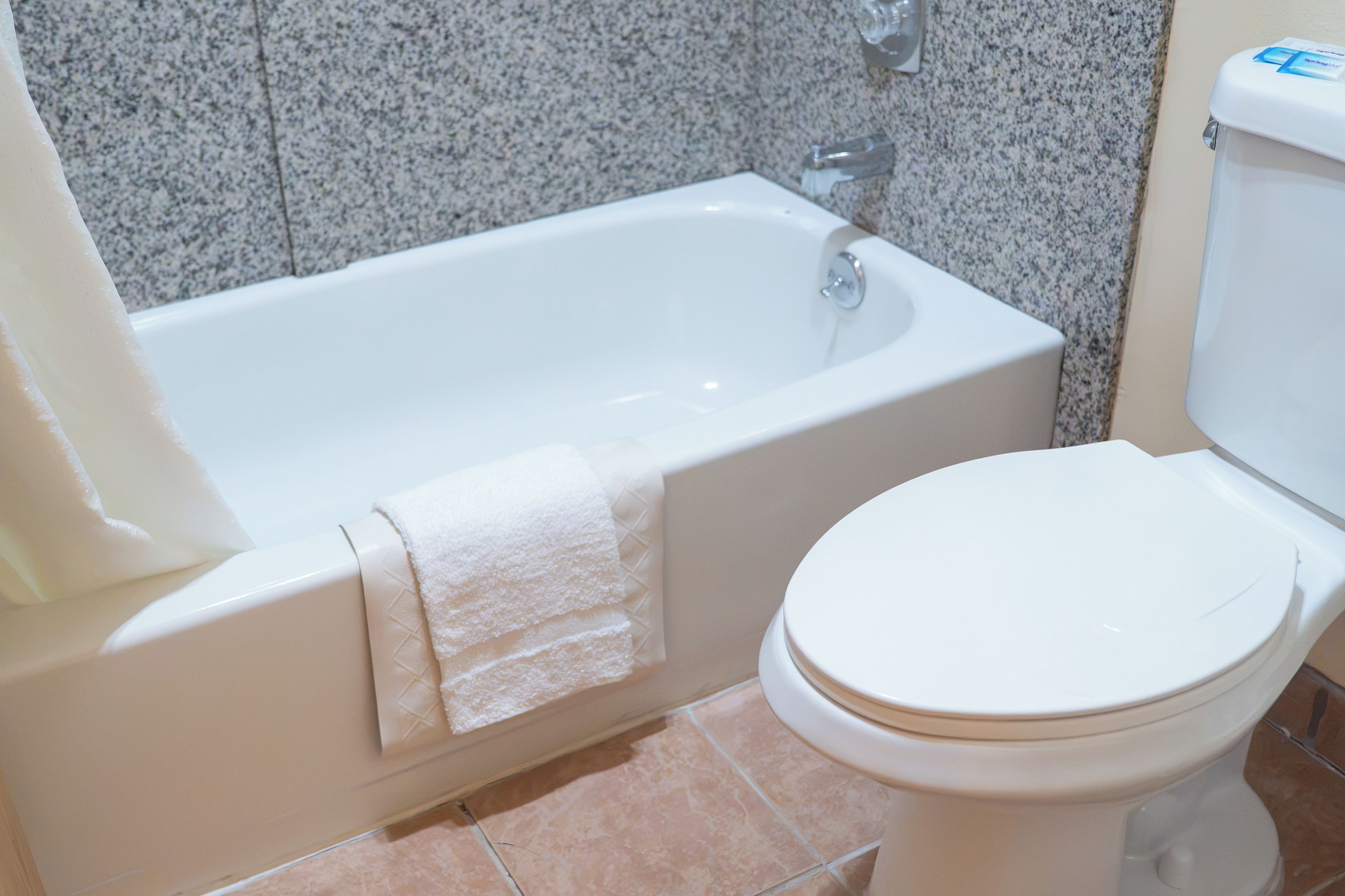 A bathroom with a bathtub and toilet.