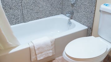A bathroom with a bathtub and toilet.