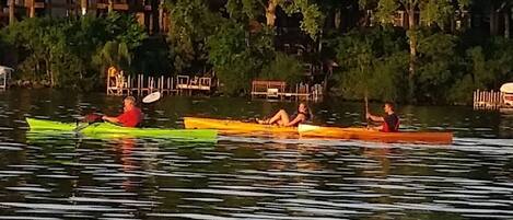 A calm lake with several kayaks.