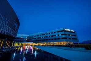 A modern hotel with a flat roof, multiple floors, and a well-lit entrance. - Aquatis Hotel (Lausanne)