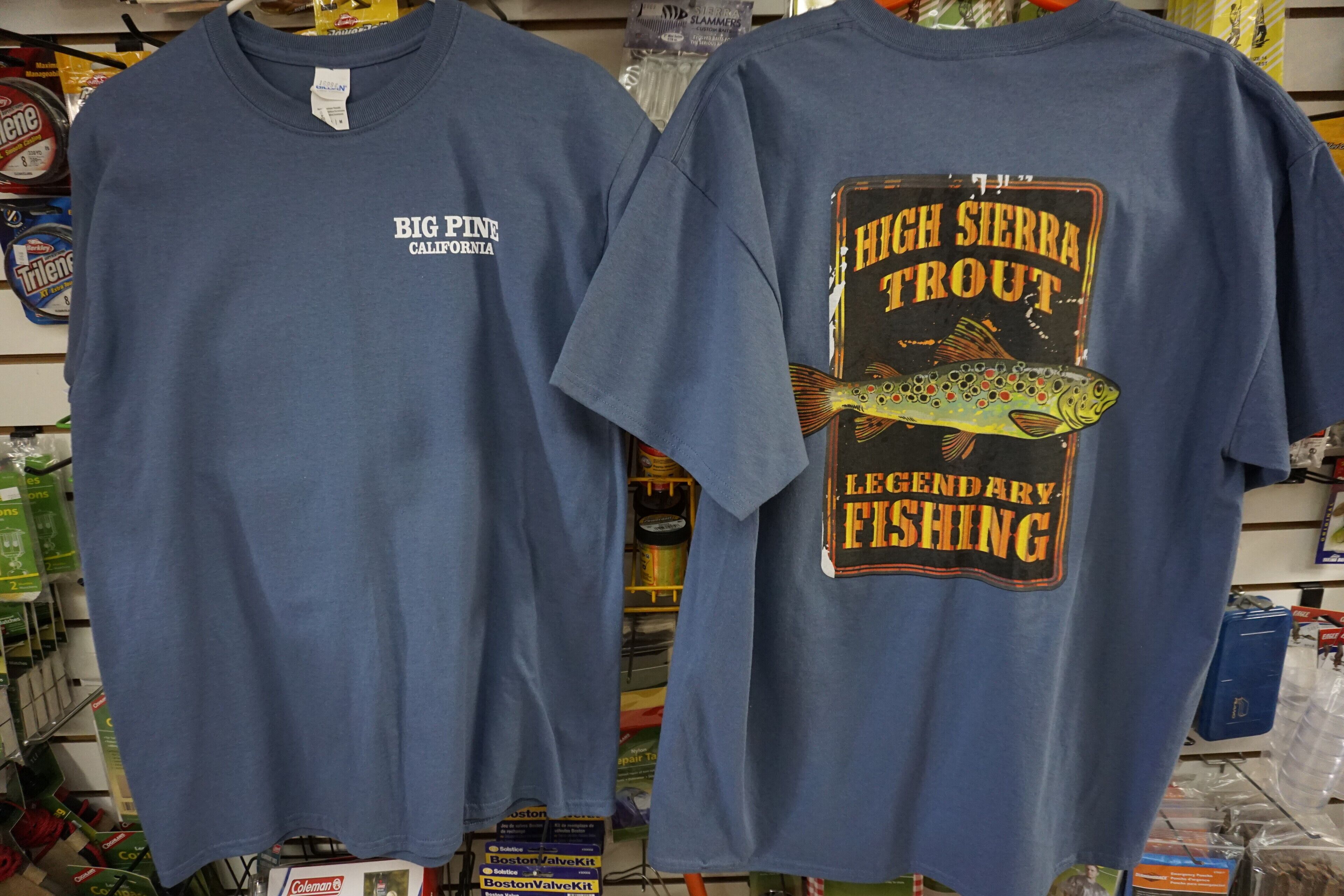 Two blue t-shirts with fishing-themed graphics and text.