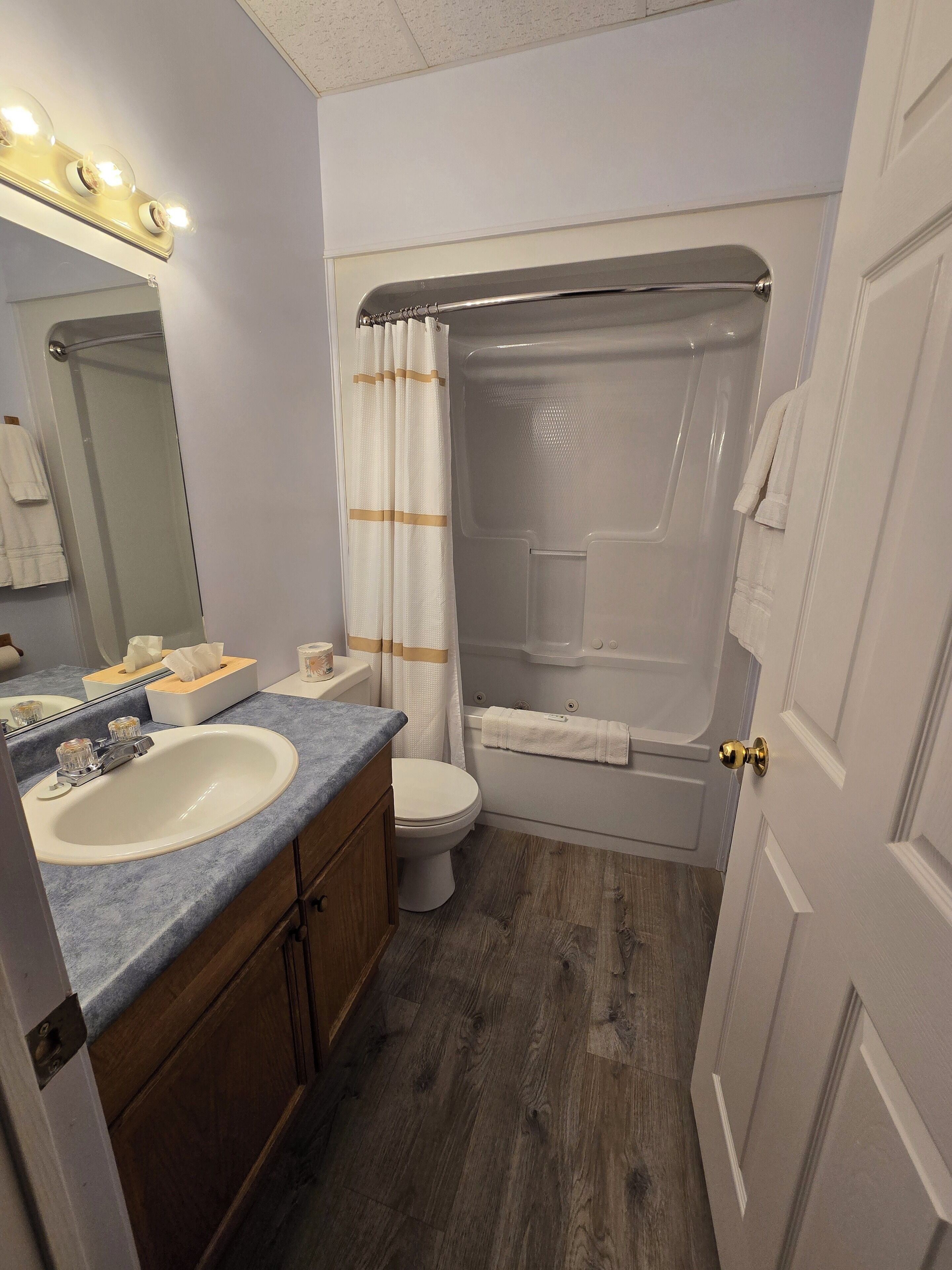 A bathroom with a sink, toilet, and bathtub.