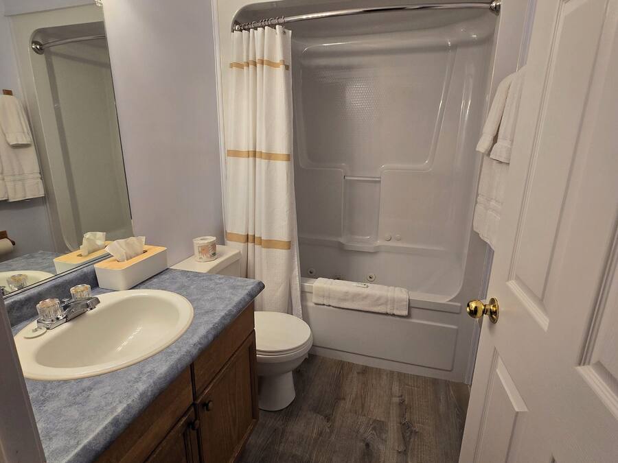 A bathroom with a sink, toilet, and bathtub.