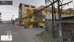 A street view with a yellow building labeled 'GV Hotel' and 'Lucky 69 Store'. - GV Hotel Ipil (Ipil)