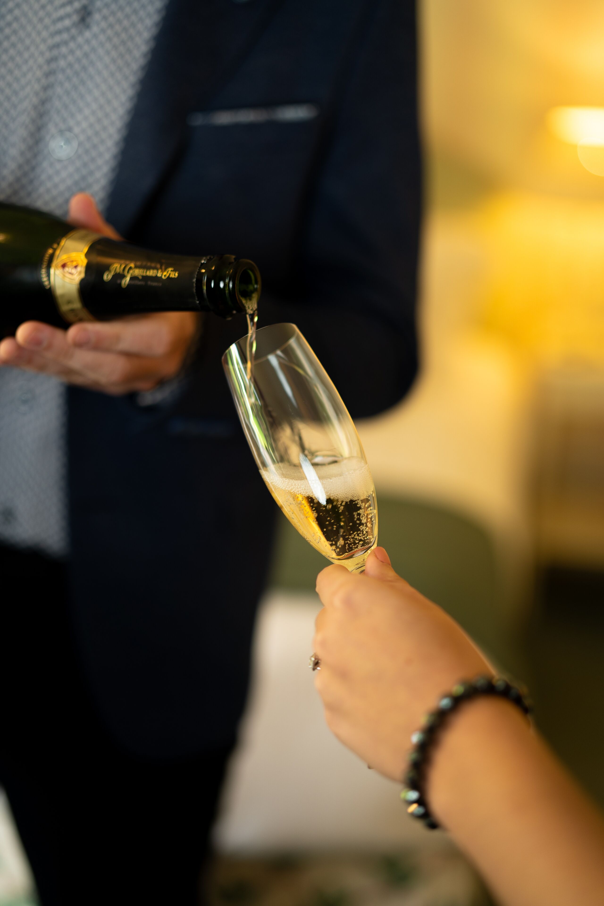 A person pouring champagne into a glass.
