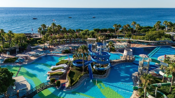 A resort with multiple swimming pools, water slides, and palm trees. - Limak Limra Hotel & Resort  (Kemer)
